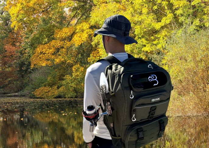 man using Baitium tackle backpack - when is the best time of day for fall fishing?